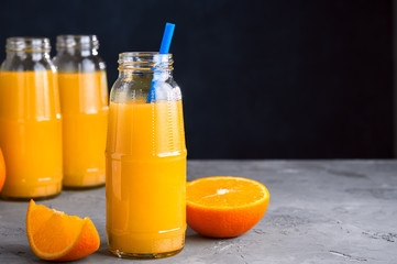 Fresh Orange Juice, Glass Bottle of Juice,Wooden Tray, Straws,Copy Space.