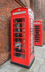 Two typical telephone booths on a street in London