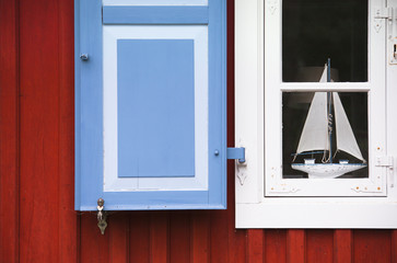 Window with shutters and sailing boat