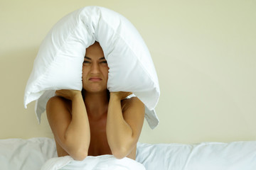 Woman with pillow on her head