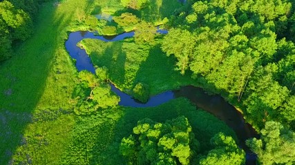 Aerial flight over river valley in beautiful sunset light