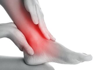 Woman is touching her injured ankle