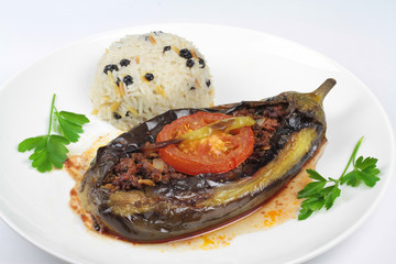 Turkish cuisine. Karniyarik and rice pilaf with dried black corinth raisin. Eggplant stuffed ground meat.