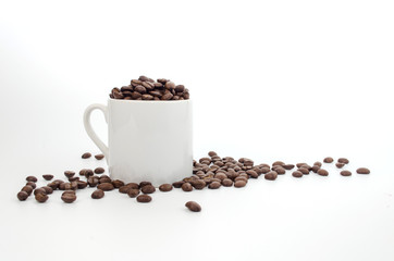 coffee beans and white coffee cup on white background