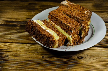 Biscuit cake in plastic container on wooden table