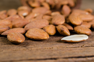 almond from wooden bowl on wooden board
