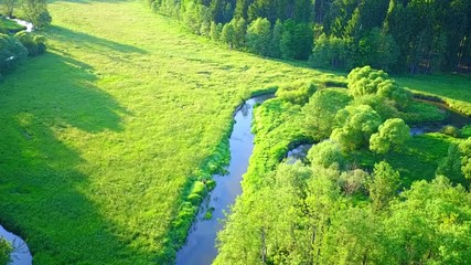 Aerial flight over river valley in beautiful sunset light