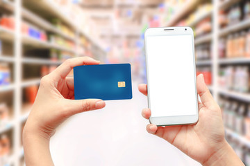 Online shopping Concept / Hands using smartphone and holding credit card.