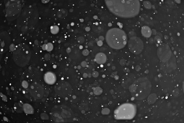 Obraz na płótnie Canvas snow on a black background texture overlay bokeh highlights