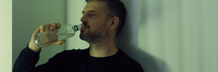 Drinker with bottle of vodka