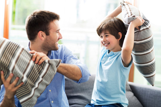 Father And Son Having Pillow Fight
