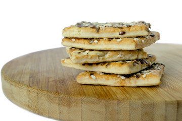 Cereal cookies stacked on top of each other. Wooden plank. White background