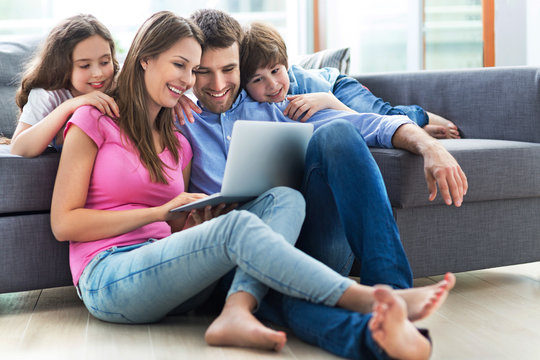 Family using laptop at home
