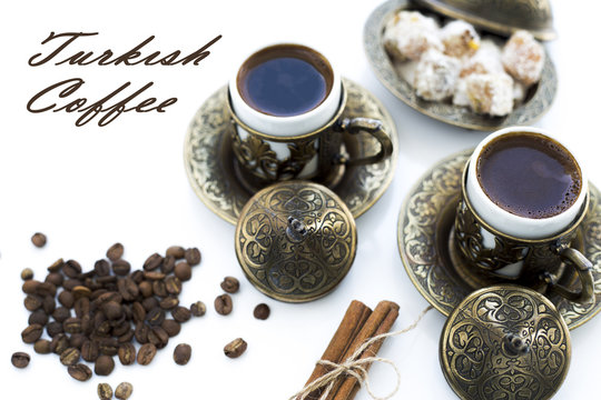 Turkish coffee with delight and traditional copper serving set on white background