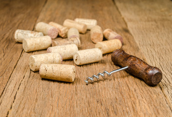 corkscrew for open wine bottle on wooden background