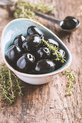 Bowl filled with fresh black olives