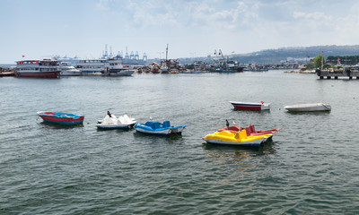 Fototapeta na wymiar Colorful pleasure boats moored in small port