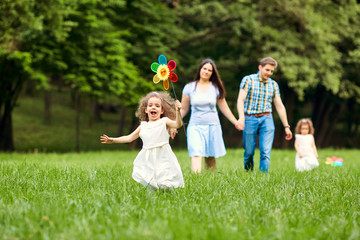 Fototapeta premium Happy family walking playing in the park.