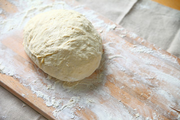Yeast dough on a floured cutting board after kneading