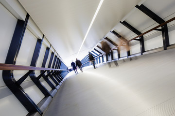 Business people walking through a pedestrian bridge in London's financial district