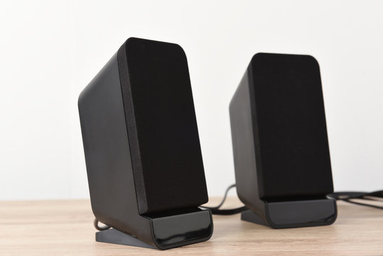 speaker computer pace on wood desk background.