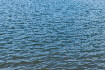 The dark water has waves for use as a background and texture.