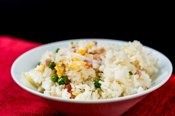 Homemade Chinese fried rice with vegetables and fried eggs