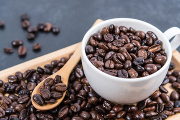 coffee cup and coffee beans on table