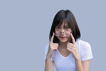 Young modern woman wearing glasses portrait on gray background.