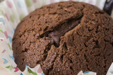 Tasty brown chocolate muffin close up still food texture