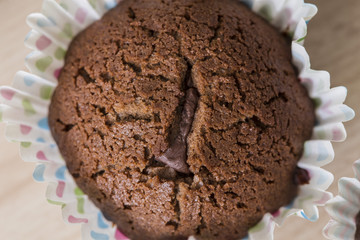 Tasty brown chocolate muffin close up still food texture