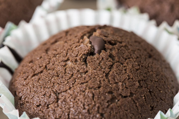 Tasty brown chocolate muffin close up still food texture