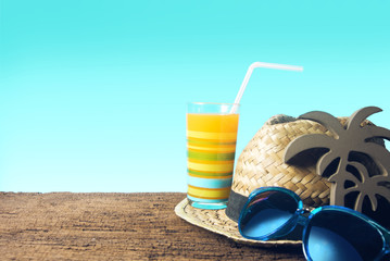 juice and hat with sunglasses and coconut tree decor wood in summer
