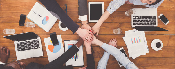 Teamwork and teambuilding concept in office, people connect hand