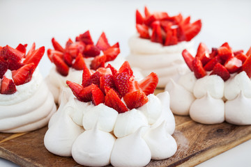 Pavlova meringue cake decorated with fresh strawberries