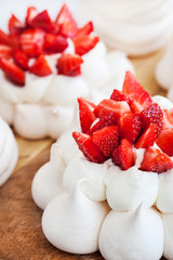 Fototapeta na wymiar Pavlova meringue cake decorated with fresh strawberries