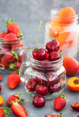 Fresh ripe summer cherry, strawberry and apricots