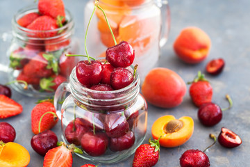 Fresh ripe summer cherry, strawberry and apricots