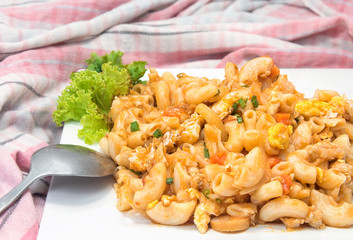 Macaroni pasta in tomato on white background.