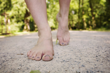 Fototapeta na wymiar Female barefoot legs walking in nature