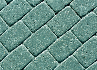 Cyan color cobblestone pavement surface.