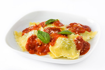 Ravioli with tomato sauce and basil isolated on white background
