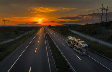 Auto Transporter Truck on a Sunset Road