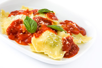 Ravioli with tomato sauce and basil isolated on white background
