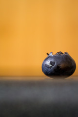 Fototapeta premium Ripe Blueberry close up with Orange background-Macro
