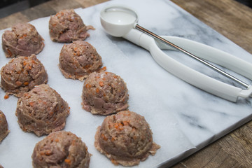 Meatballs preparation using ice cream scoop, easy trick, white marble cutting board