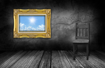 frame and wood chair in interior room with gray stone wall