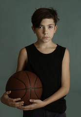 teenager boy with basketball ball close up portrai