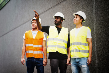 Three construction workers talking
