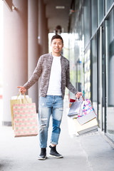 Chinese tourist with shopping bags - shopping concept